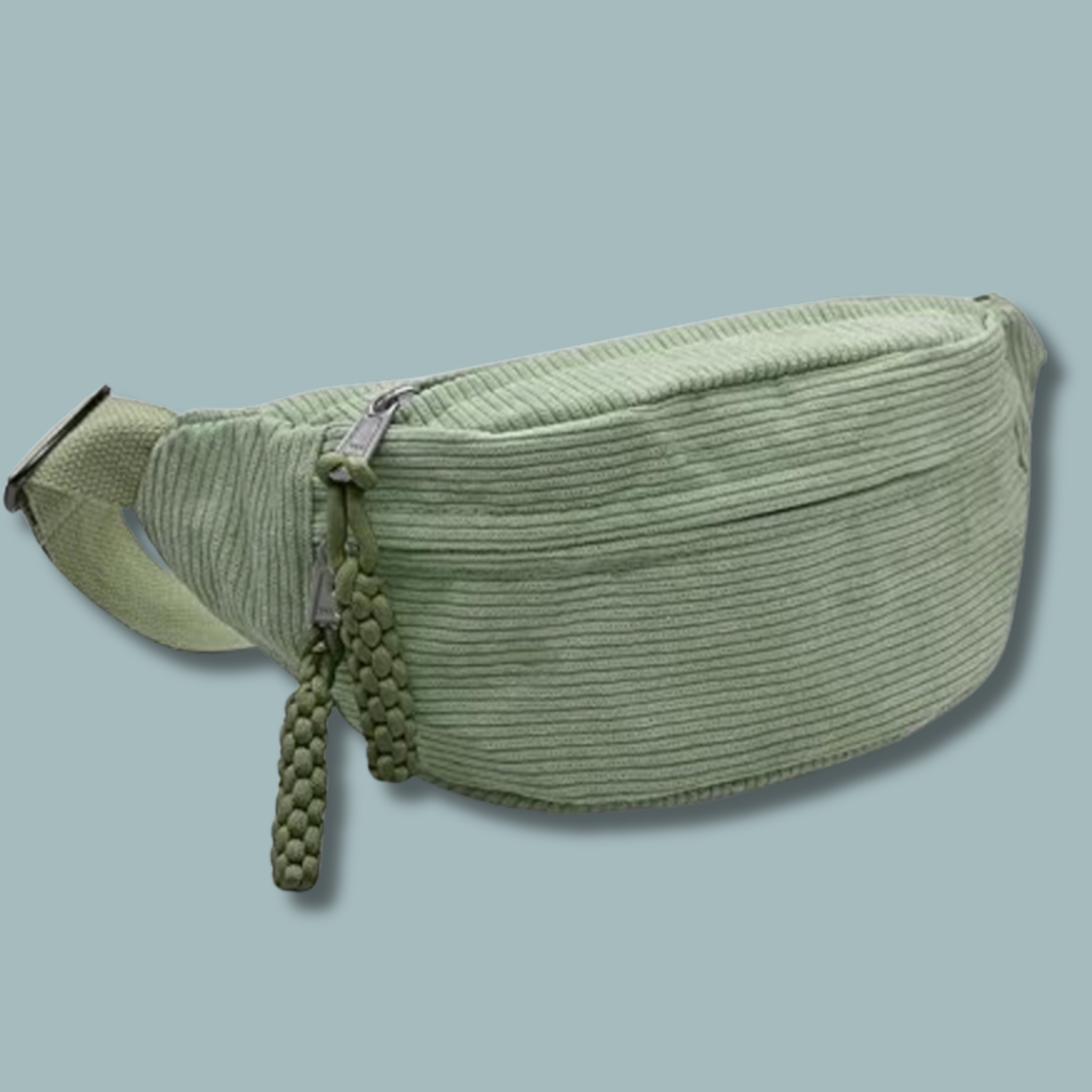 Light green cordrouy fanny pack with green braided tassle and zipper pulls.